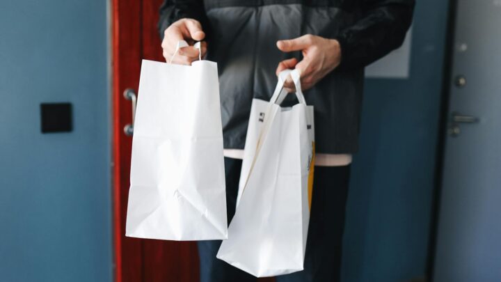 a person holding paper bags